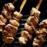 Lamb kabobs being grilled on a grill pan.