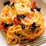 Capellini with a smoked salmon cream sauce in a bowl with a fork.