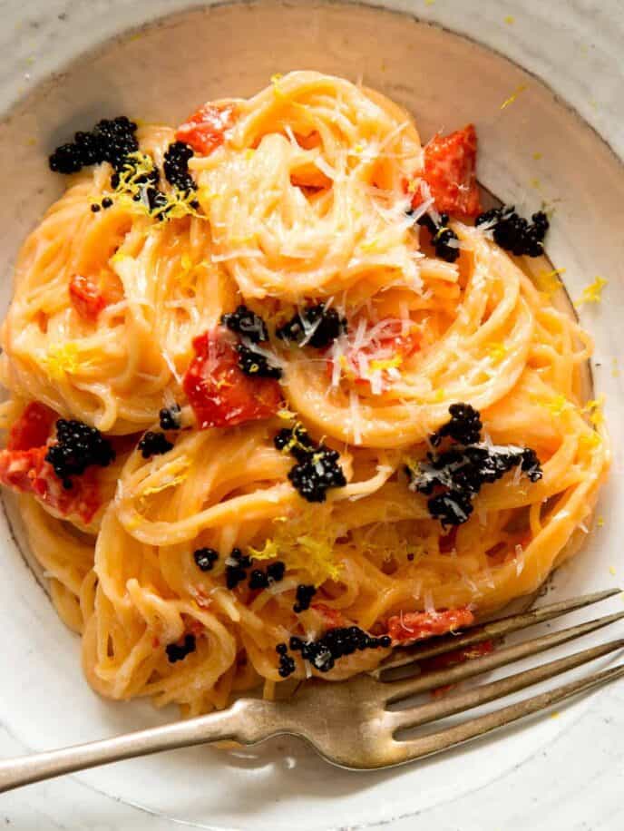 Capellini with a smoked salmon cream sauce in a bowl with a fork.