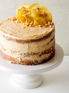 Apple and thyme cake with salted caramel buttercream on a cake stand.