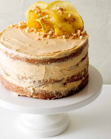 Apple and thyme cake with salted caramel buttercream on a cake stand.