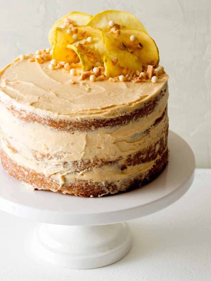 Apple and thyme cake with salted caramel buttercream on a cake stand. 