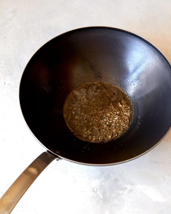 Garlic sautéd with butter in a wok.