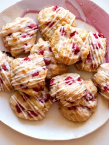 A stack of Strawberry shortcake cookies on a pink plate.