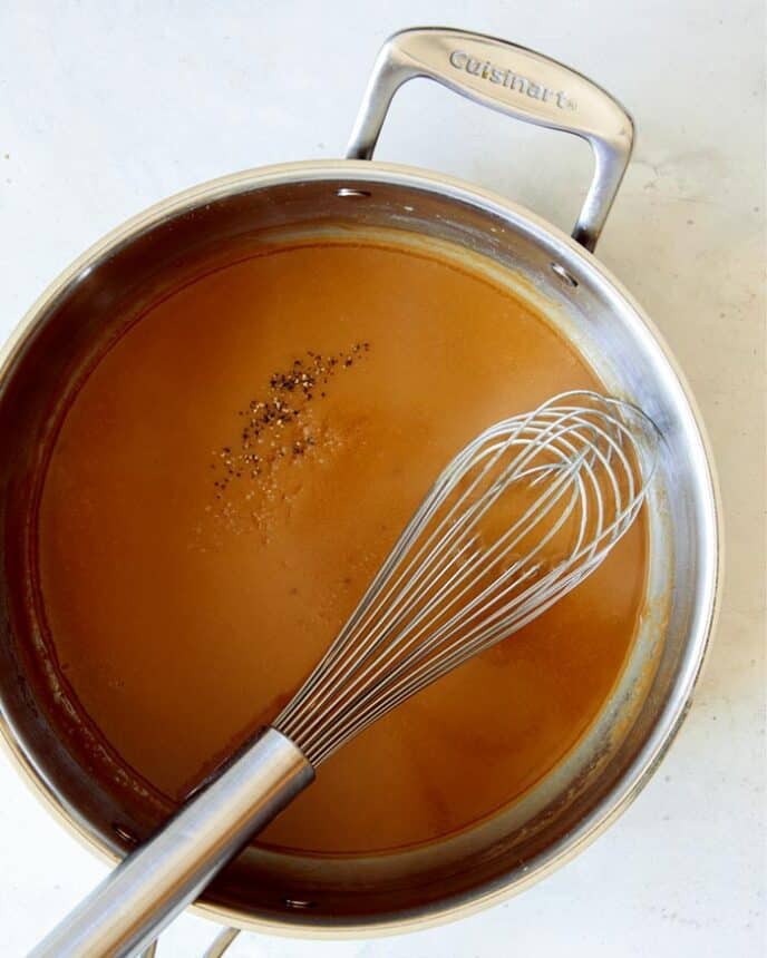 Gravy made in a skillet for Swedish Meatballs with a whisk.