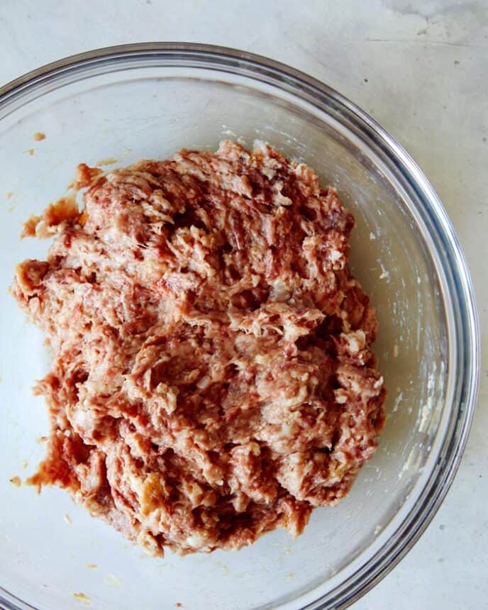 Swedish Meatball mixture in a glass bowl ready to be balled up. 