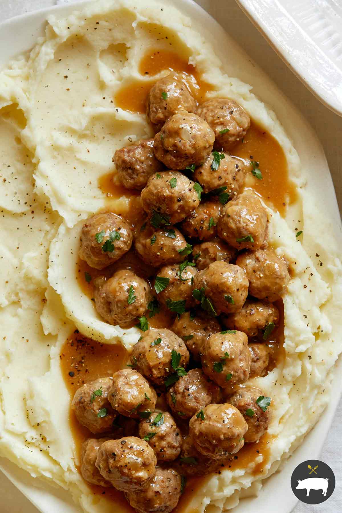 Close up on Swedish Meatballs recipe on a plate with mashed potatoes.