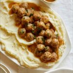 Mini Swedish Meatballs recipe on a plate with mashed potatoes.