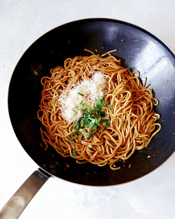 Cooked garlic noodles tossed with parmesan and green onions.