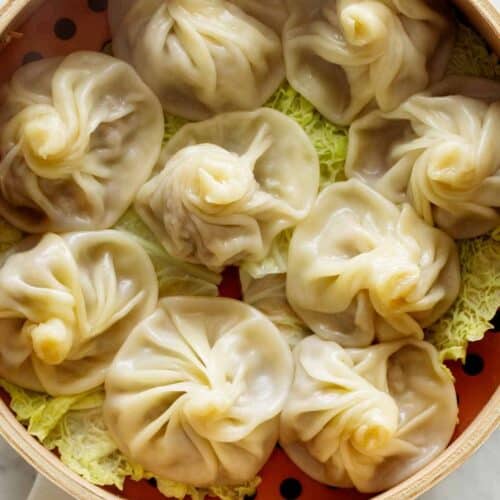 Shanghai Soup Dumplings in a steamer with cabbage.