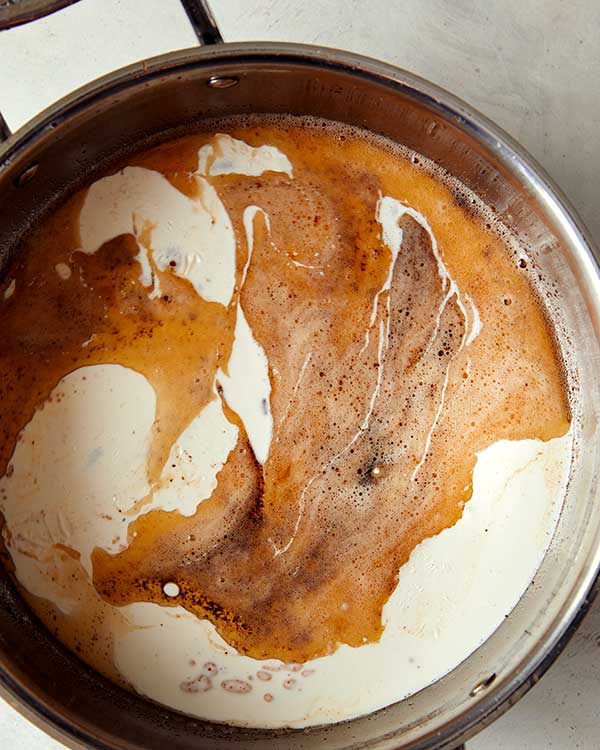 A skillet with browned butter and cream added to it. 