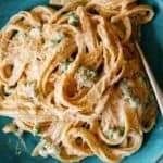 Browned Butter Fettuccine alfredo with peas on a plate with a fork in the pasta.