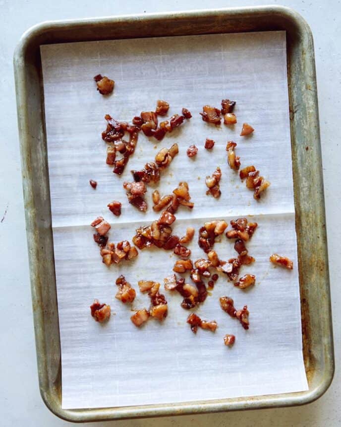 Candied pancetta hardening on a baking sheet.