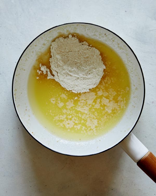 Melt butter and flour into a stock pot for cheese sauce.