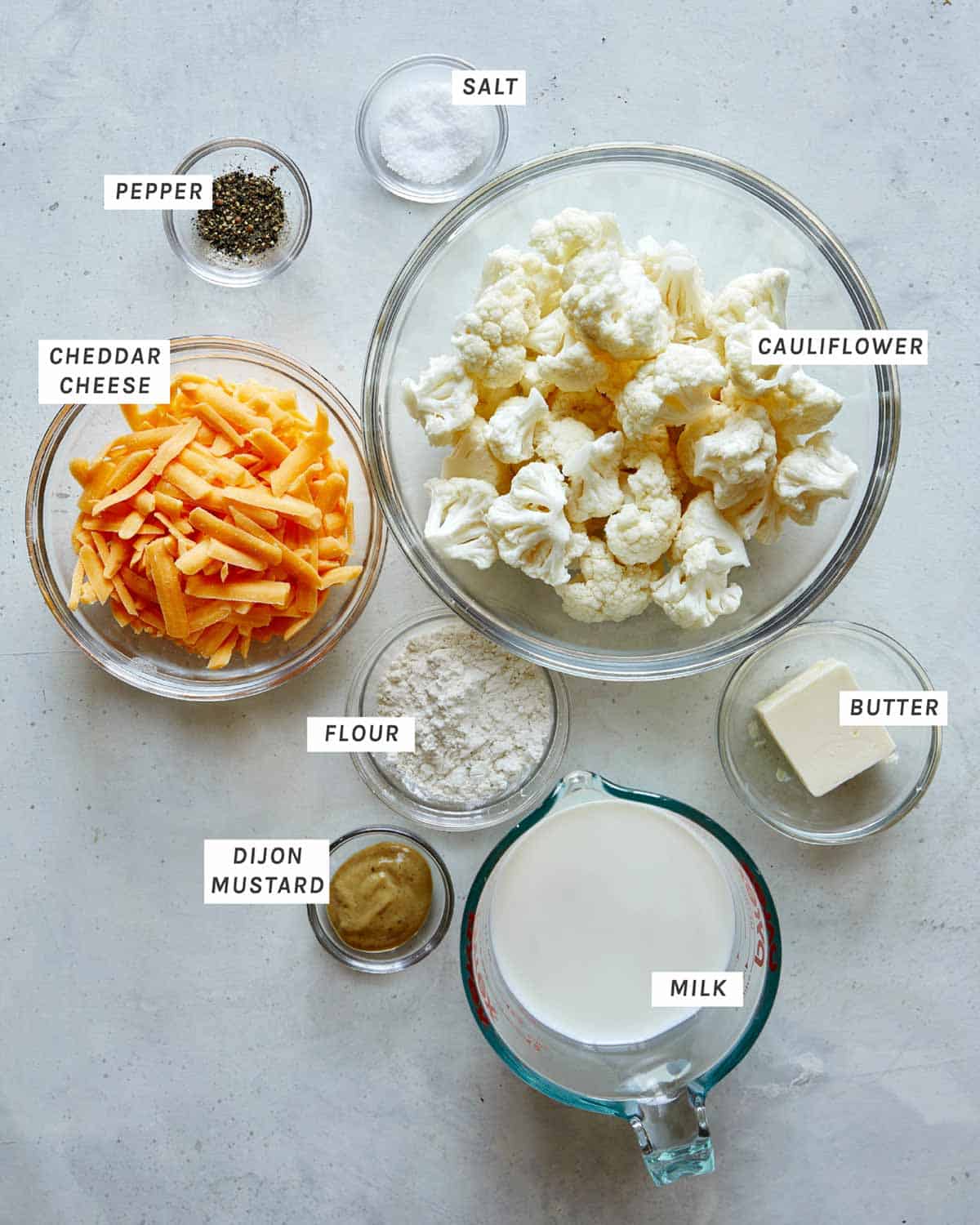 Cauliflower mac and cheese ingredients overhead on a kitchen counter. 