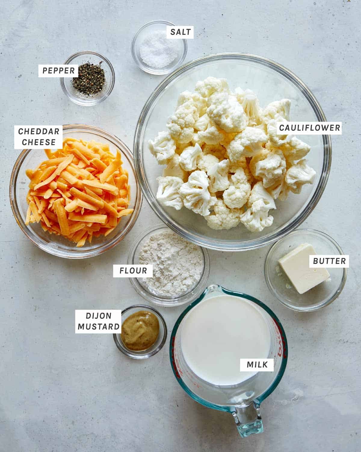 Cauliflower mac and cheese ingredients overhead on a kitchen counter.