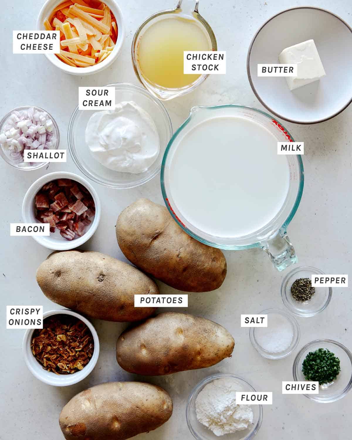 Ingredients to make Loaded Baked Potato Soup laid out on a kitchen counter.