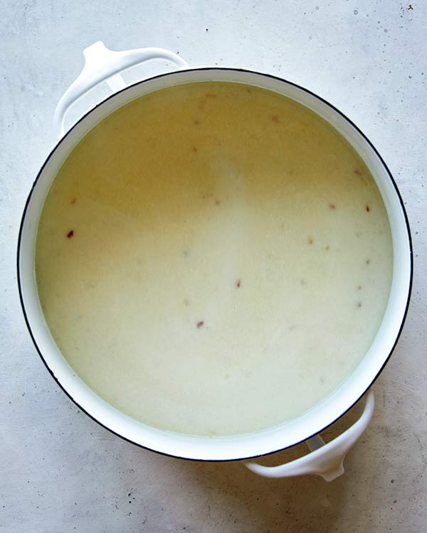 A stock pot full of the base for Loaded Baked Potato Soup.