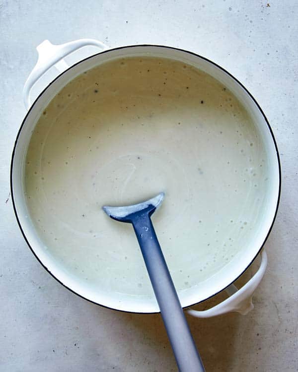Loaded baked potato soup in a pot ready to be served.