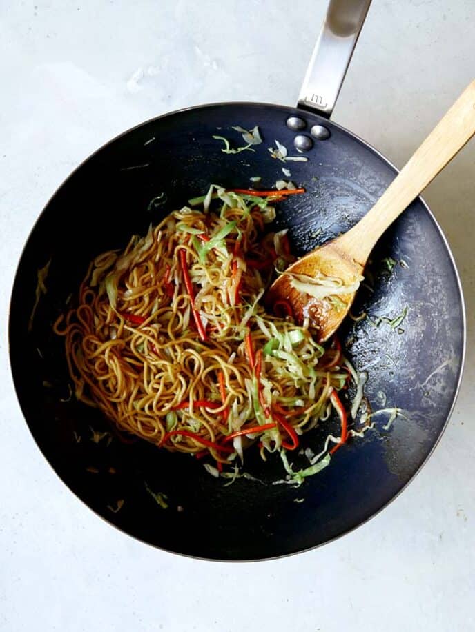 Chow Mein in a wok tossed together with the Chow Mein Sauce.