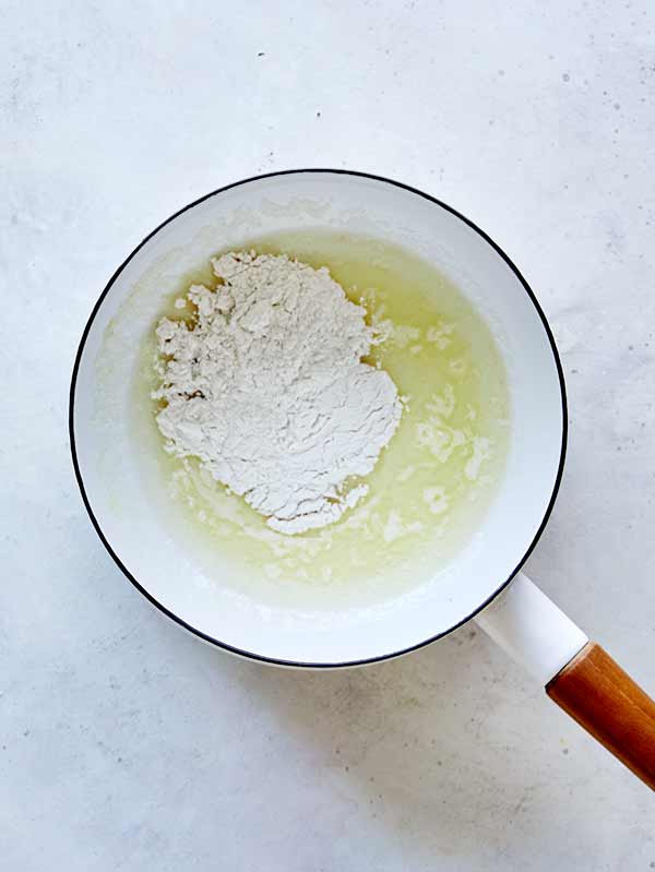 Melted butter in a saucepan with flour to make a roux.