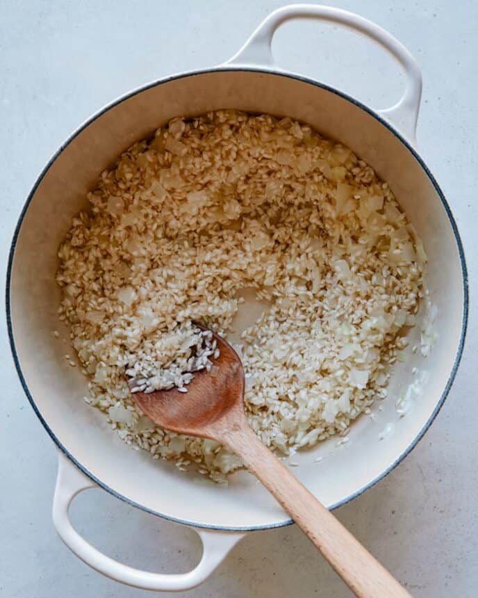 To make risotto add rice to the onion and garlic.