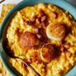 Pumpkin risotto with scallops and pancetta in a bowl.