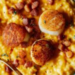 Close up on pumpkin risotto with scallops and candied pancetta.