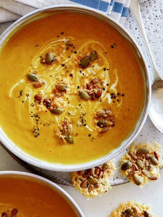 Creamy Pumpkin Soup overhead in a bowl with another bowl peeking in the frame.