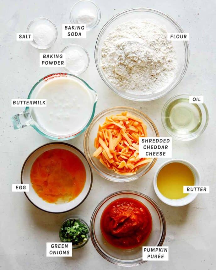Ingredients for cheesy pumpkin pancakes with all of the ingredients laid out on a kitchen counter.