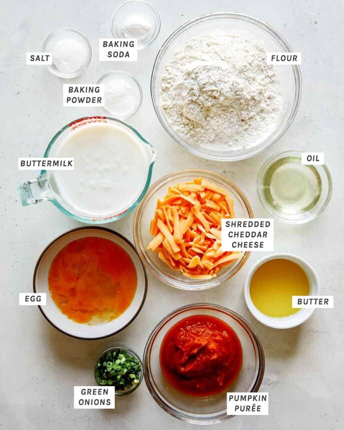 Ingredients for cheesy pumpkin pancakes with all of the ingredients laid out on a kitchen counter. 