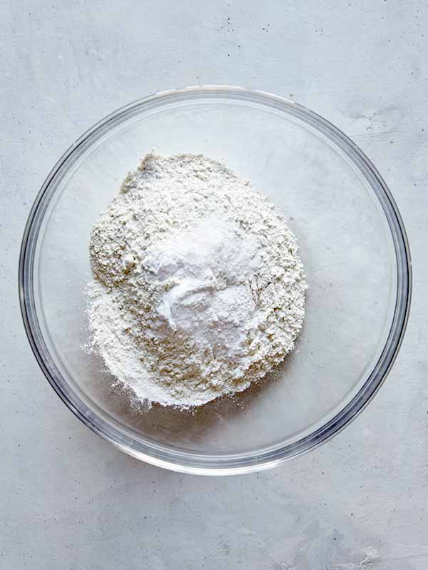 Whisking together flour and other ingredients to make Pumpkin Pancakes.