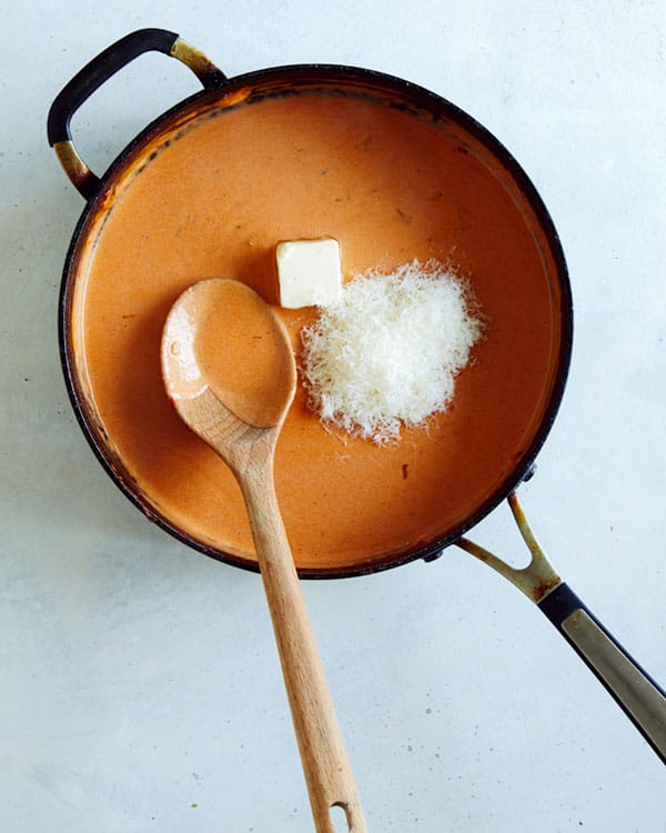 Vodka sauce with butter and parmesan in a skillet ready to be stirred in.