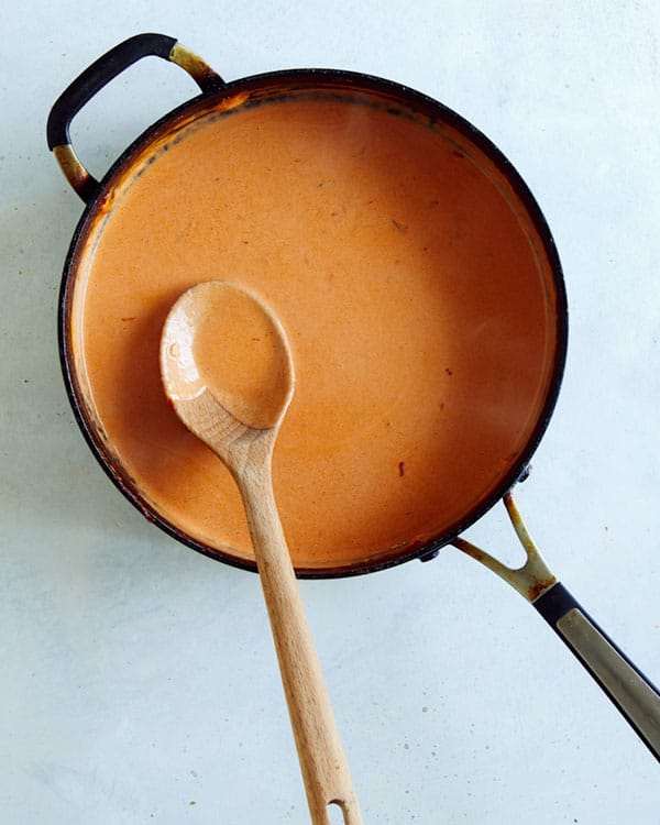 A skillet of vodka sauce simmering.