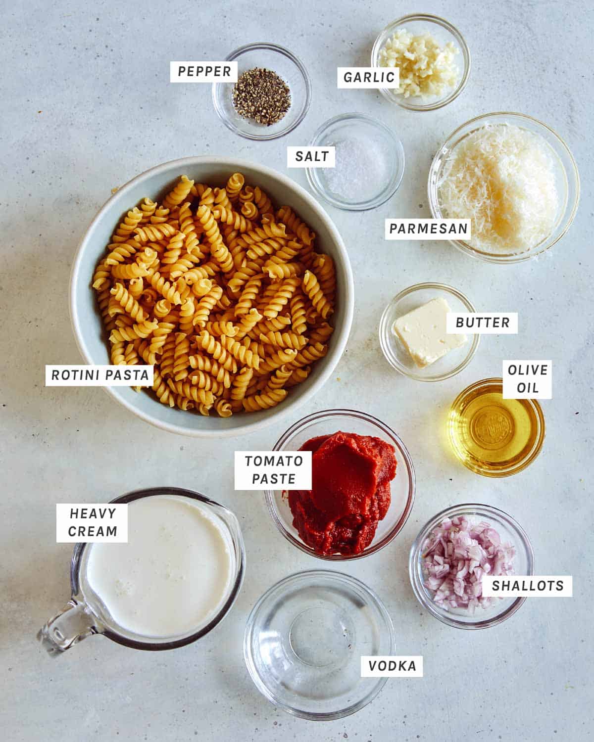 Vodka sauce ingredients all laid on a kitchen counter. 