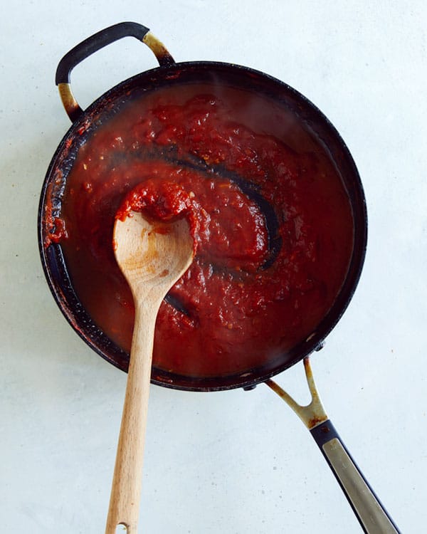 Vodka with tomato paste cooking in a skillet.