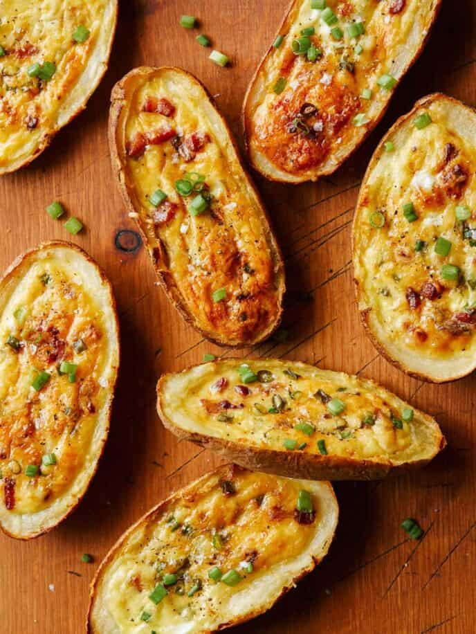 Several potato skin egg boats on wood.