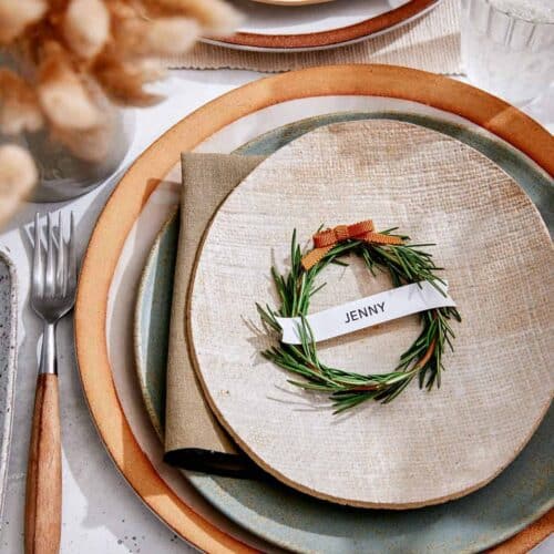 Rosemary Wreath Place Card on a plate in a table setting.