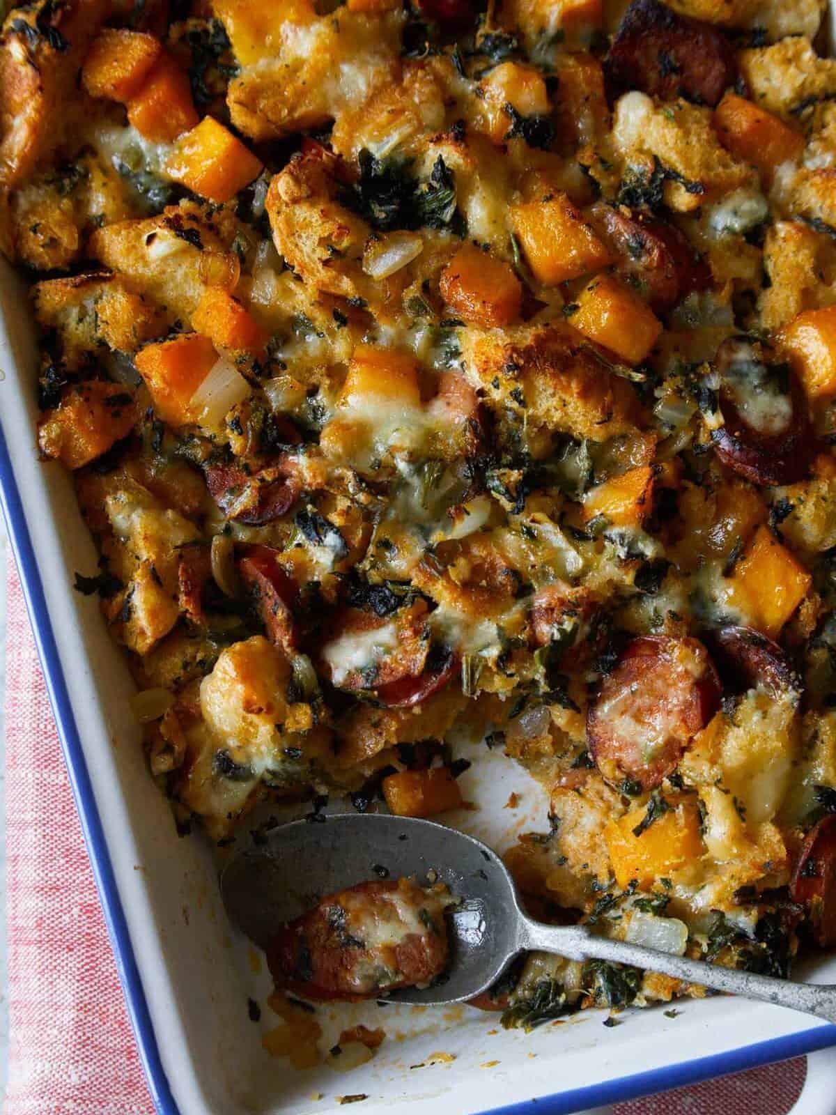 A close up of butternut squash sage stuffing with a spoon.