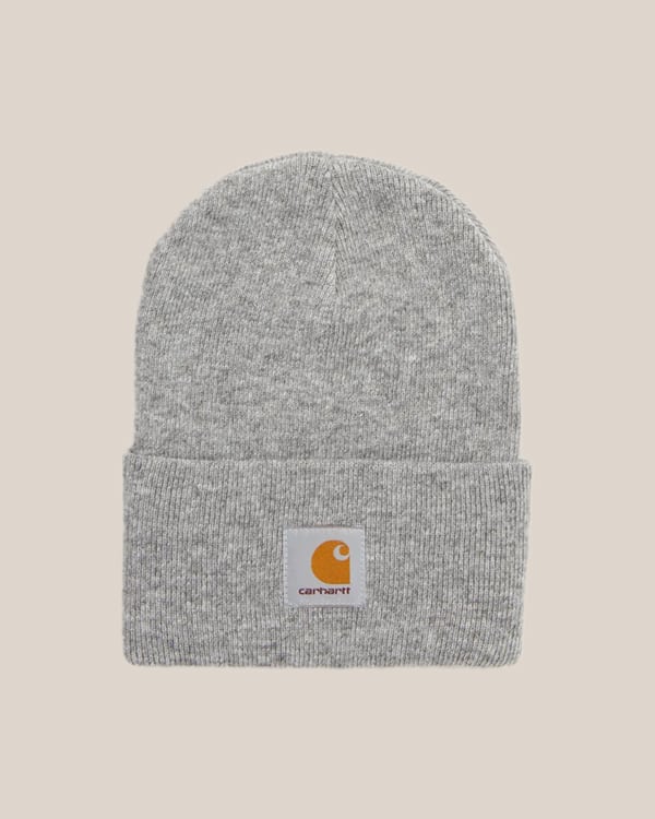 A gray beanie on a tan background. 