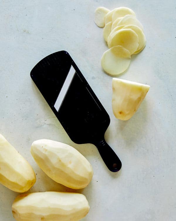 Slice potatoes thinly on a mandolin.