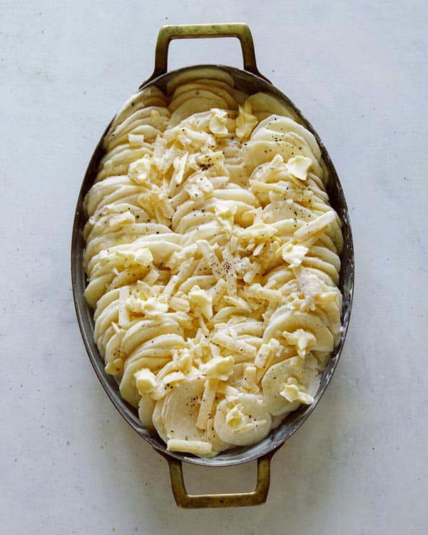 Potatoes gratin with cheese on top pre bake.