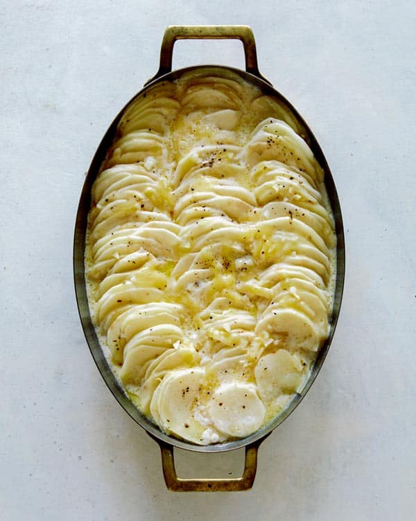 Potatoes gratin with salt and pepper on top.