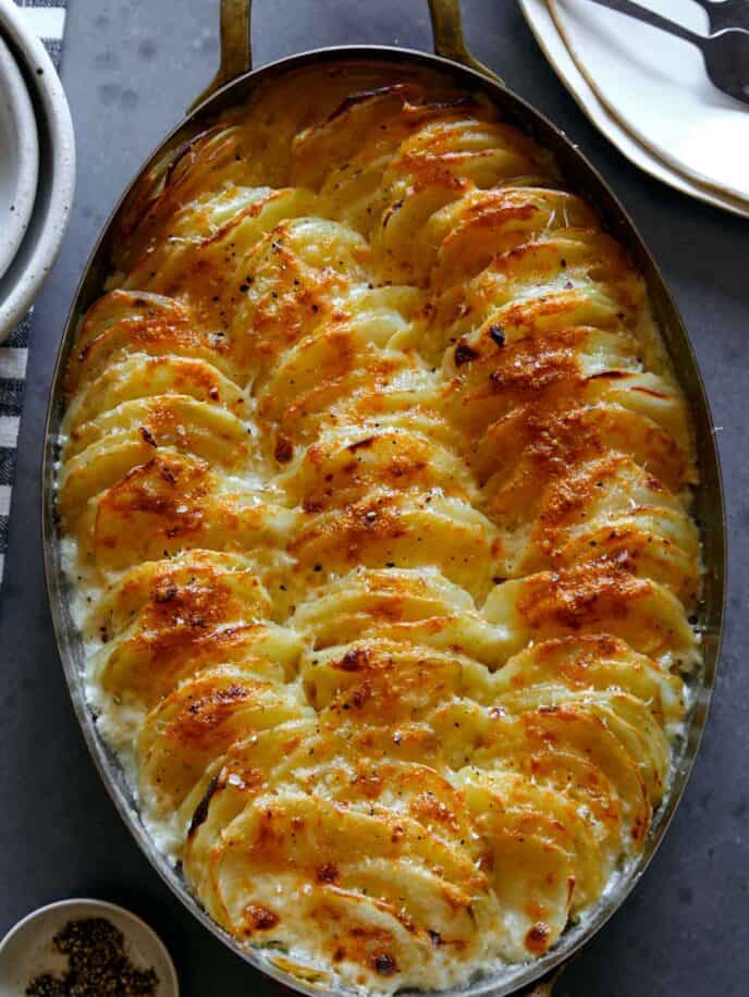 Close up on a casserole dish of cheesy potatoes gratin.