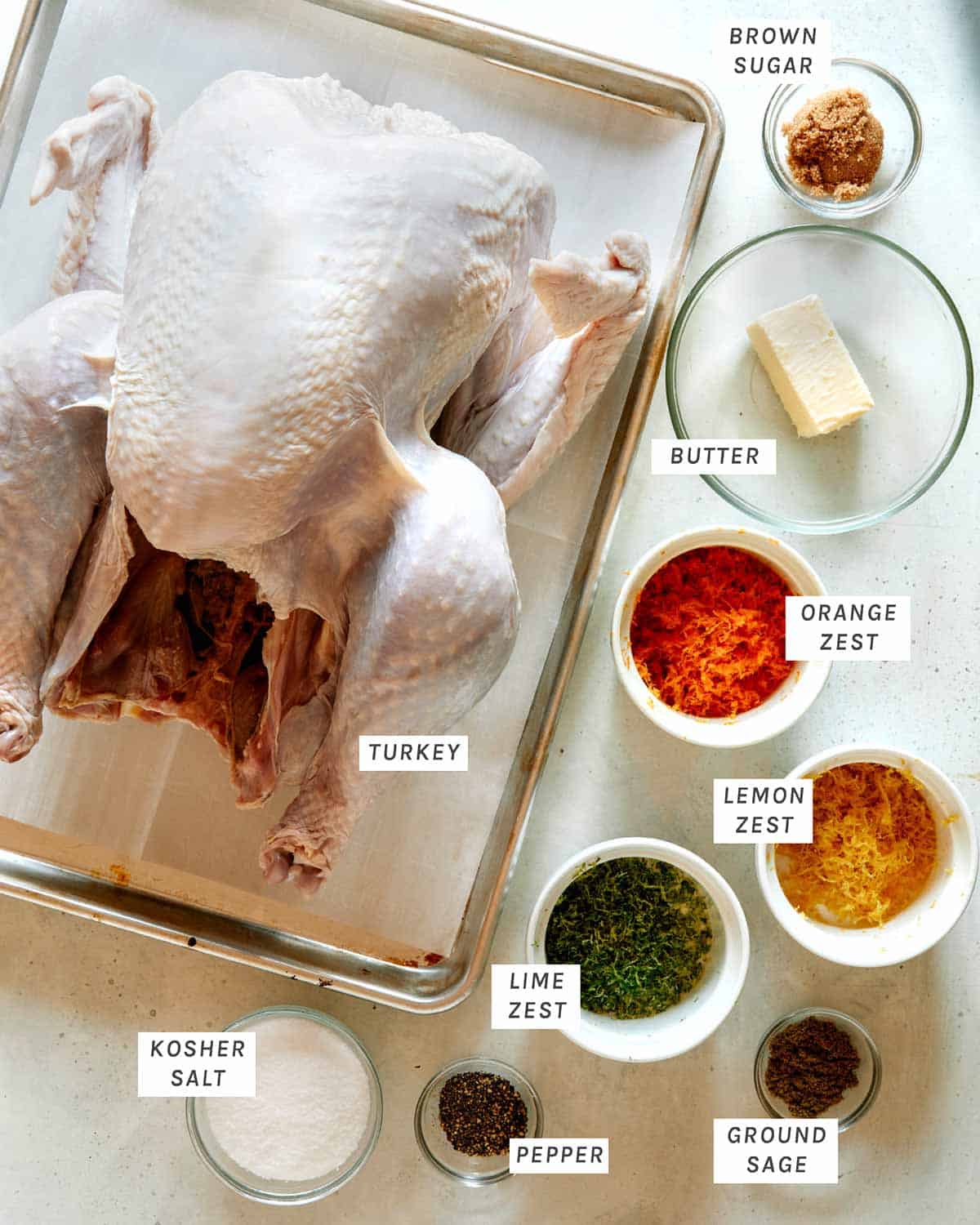 Ingredients for a citrus dry brined turkey laid out on a kitchen counter. 