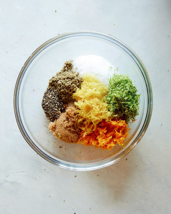 Ingredients for a citrus dry brine for a turkey in a glass bowl.