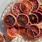 Dehydrated blood oranges on a plate. slices