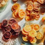 Dehydrated citrus on a surface on plates with fresh citrus.