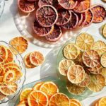 Various typed of dehydrated citrus wheels on a plates.