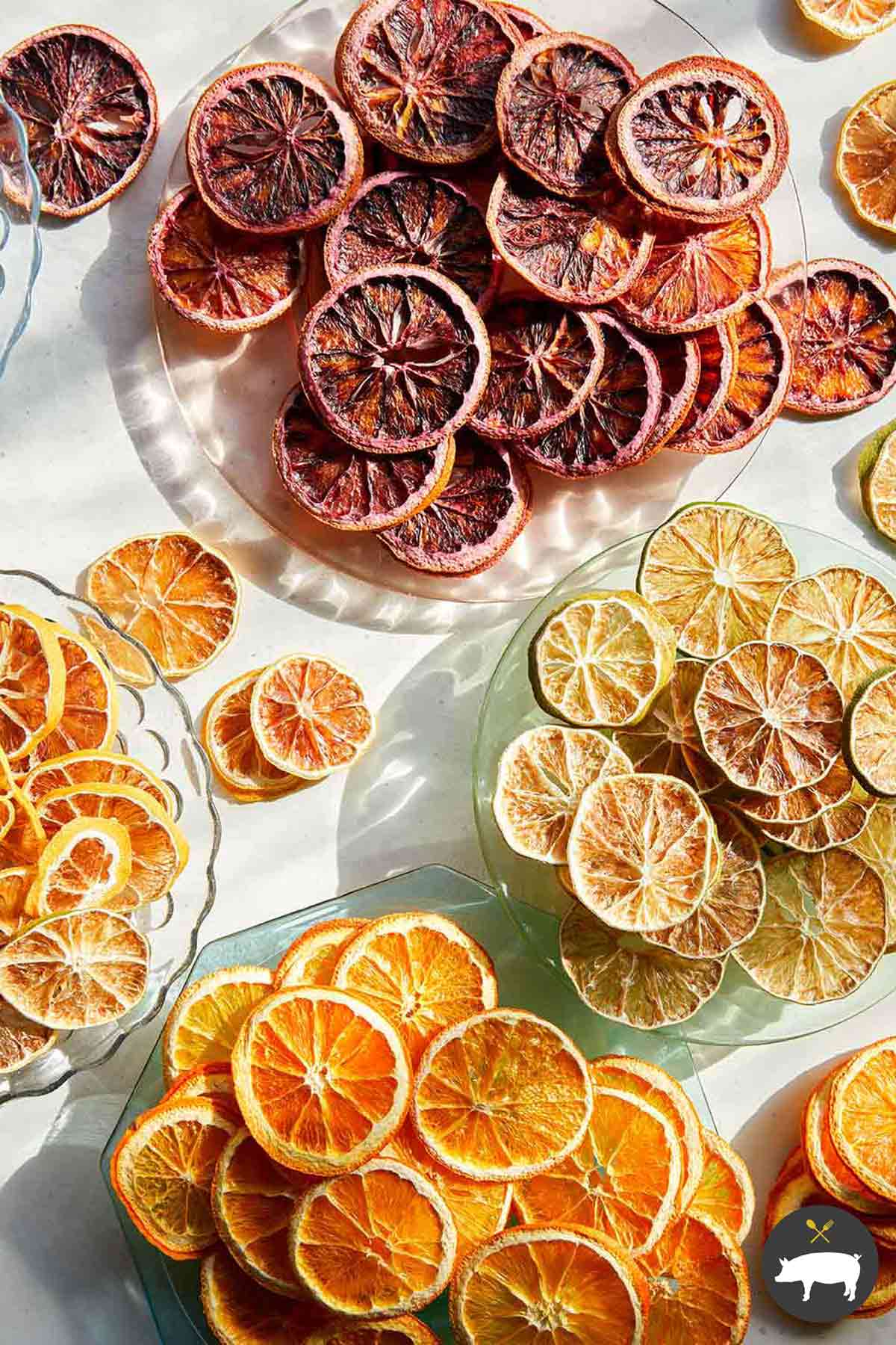 Various typed of dehydrated citrus wheels on a plates.